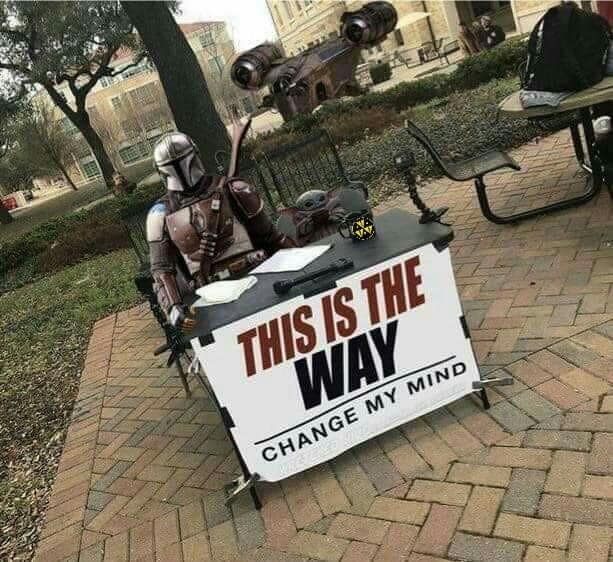 The meme is an image of the character Din Djarin (also known as "The Mandalorian") from the Star Wars franchise, sitting at a desk with a sign that reads "This is the way". However, the sign is modified to read "This is the way... change my mind". The image is likely a humorous take on the character's iconic phrase, implying that even he is questioning his own philosophy.